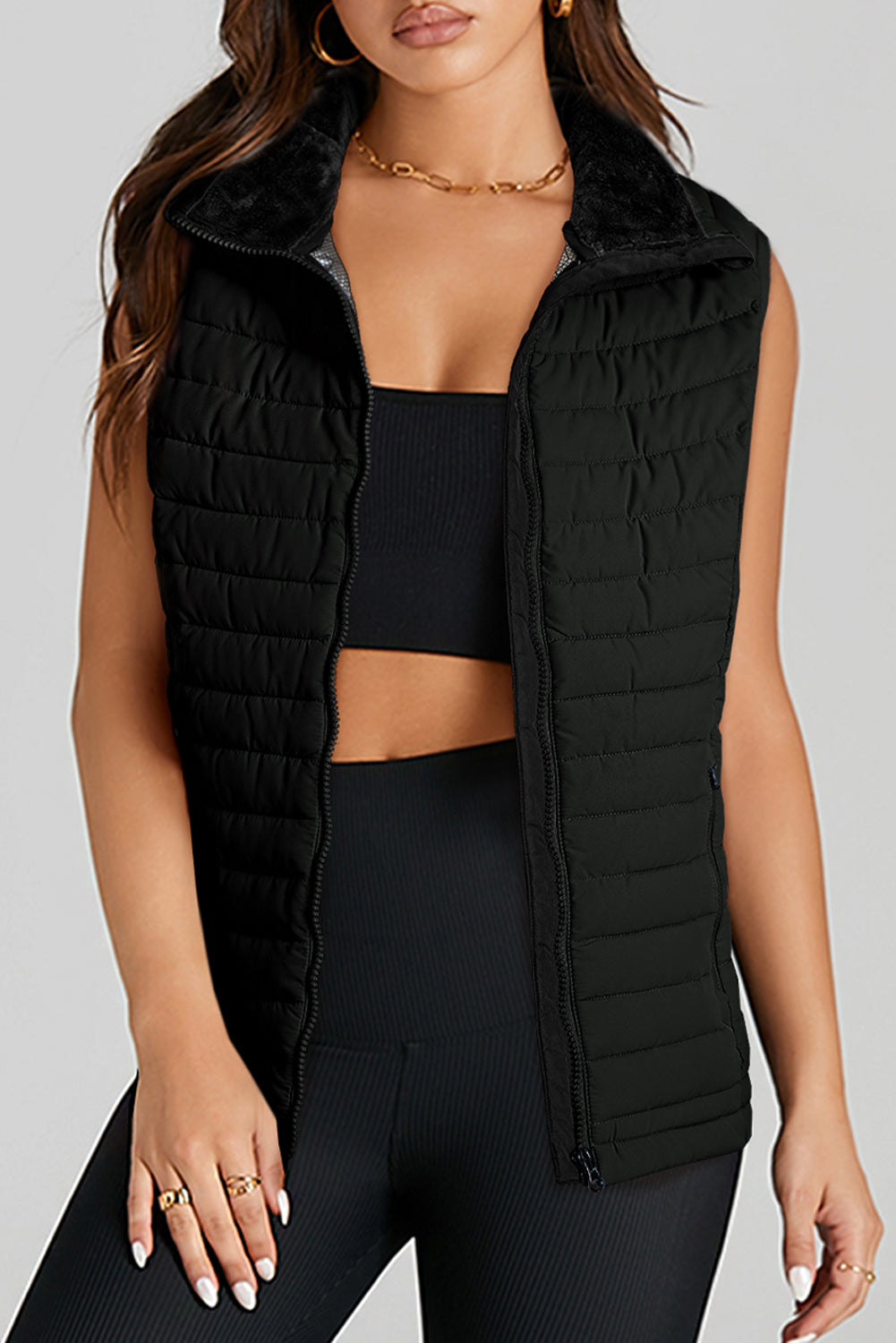 Stay on trend (and warm!) with this Black Quilted Zipped Puffer Vest. Versatile for any occasion, this vest is perfect for layering over any outfit. Plus, its unique quilted design and zip closure add a touch of style. Don't miss out on this must-have piece! front view