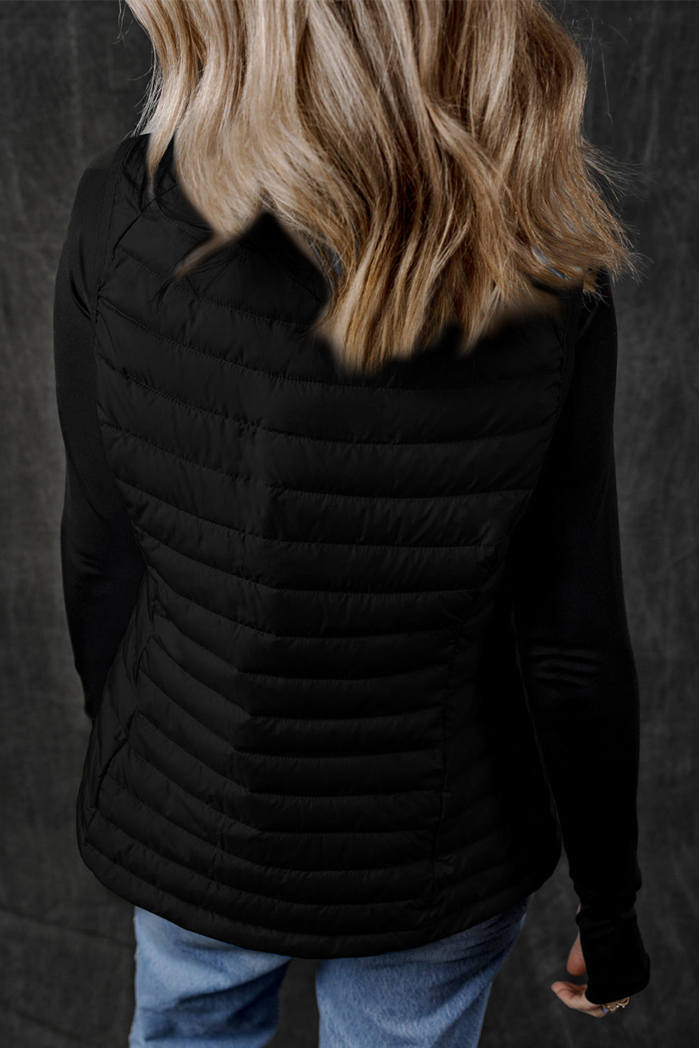 Stay on trend (and warm!) with this Black Quilted Zipped Puffer Vest. Versatile for any occasion, this vest is perfect for layering over any outfit. Plus, its unique quilted design and zip closure add a touch of style. Don't miss out on this must-have piece! back view