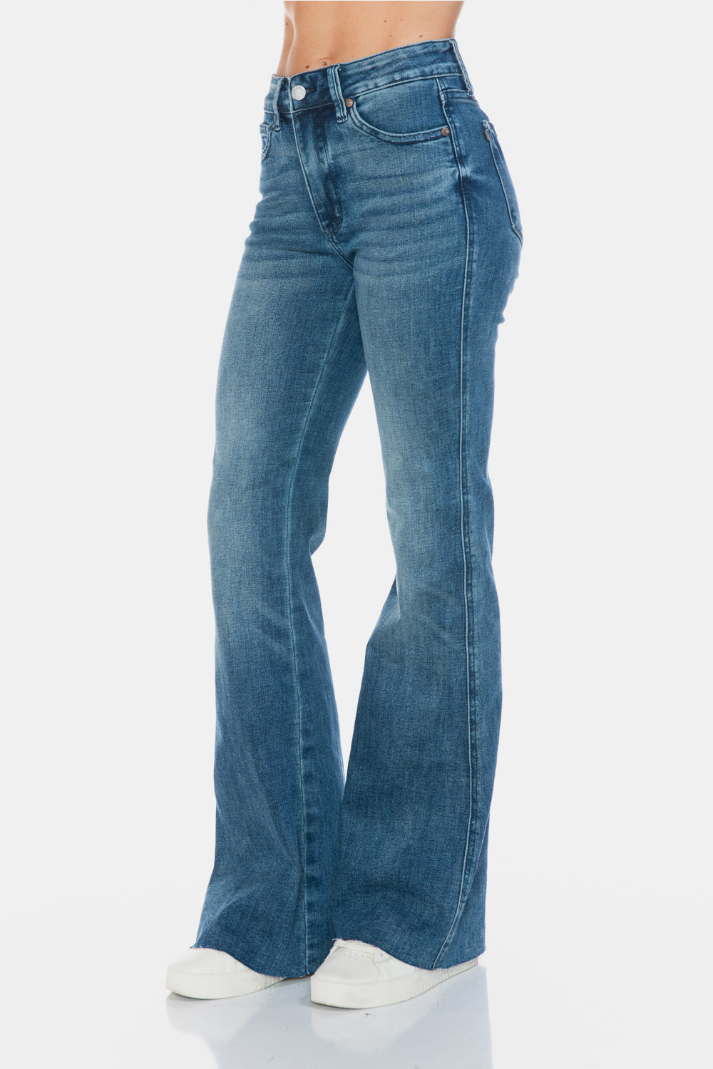 Judy Blue Mid-Rise Tummy Control Vintage Wash Cut Hem Flare is a stylish and flattering pair of jeans. With its tummy control feature, it helps create a streamlined silhouette. The vintage wash gives it a classic and timeless look. The cut hem flare adds a modern twist to the design. Perfect for any occasion, these jeans are versatile and comfortable to wear. Elevate your wardrobe with the Mid-Rise Tummy Control Vintage Wash Cut Hem Flare! Front left angle view