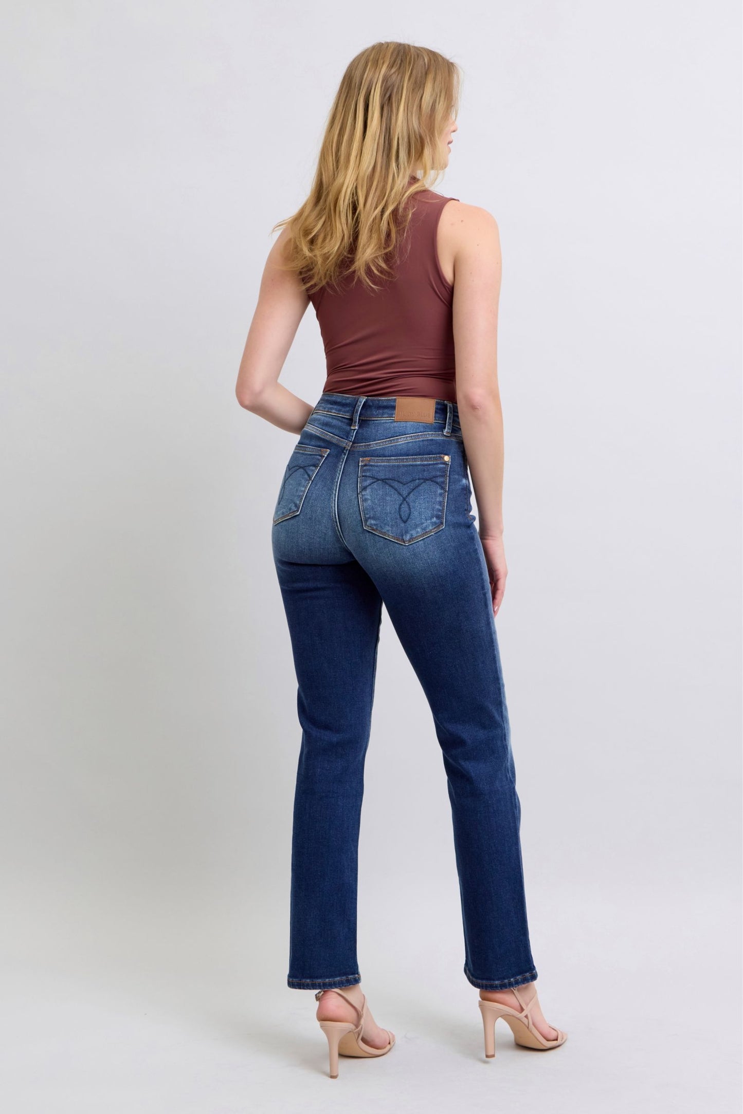 Judy Blue Washed Straight Leg Jeans with Pockets are a practical and fashionable choice for your everyday wardrobe. The washed finish gives them a laid-back and casual feel, while the straight leg cut offers a flattering silhouette. The addition of pockets adds functionality and convenience, making these jeans a perfect blend of style and practicality. Back view