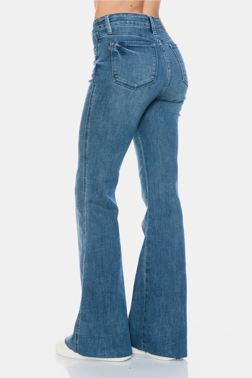 Judy Blue Mid-Rise Tummy Control Vintage Wash Cut Hem Flare is a stylish and flattering pair of jeans. With its tummy control feature, it helps create a streamlined silhouette. The vintage wash gives it a classic and timeless look. The cut hem flare adds a modern twist to the design. Perfect for any occasion, these jeans are versatile and comfortable to wear. Elevate your wardrobe with the Mid-Rise Tummy Control Vintage Wash Cut Hem Flare! Back left angle view