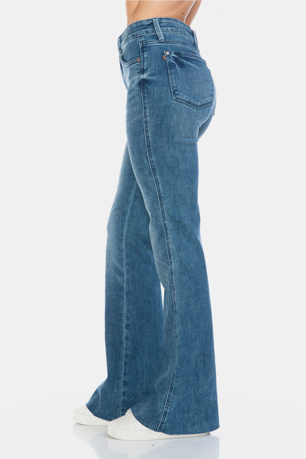 Judy Blue Mid-Rise Tummy Control Vintage Wash Cut Hem Flare is a stylish and flattering pair of jeans. With its tummy control feature, it helps create a streamlined silhouette. The vintage wash gives it a classic and timeless look. The cut hem flare adds a modern twist to the design. Perfect for any occasion, these jeans are versatile and comfortable to wear. Elevate your wardrobe with the Mid-Rise Tummy Control Vintage Wash Cut Hem Flare! Left side view