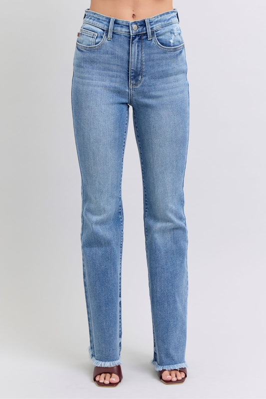 Judy Blue Raw hem high rise bootcut jeans are a trendy and stylish denim option for a fashionable look. These jeans feature a high-rise waist that sits above the natural waistline, elongating the legs and providing a flattering silhouette. The bootcut style flares out slightly from the knee down, creating a balanced and vintage-inspired look. The raw hem detail at the bottom adds a modern and edgy touch to the jeans, giving them a unique and on-trend appearance.  Front view