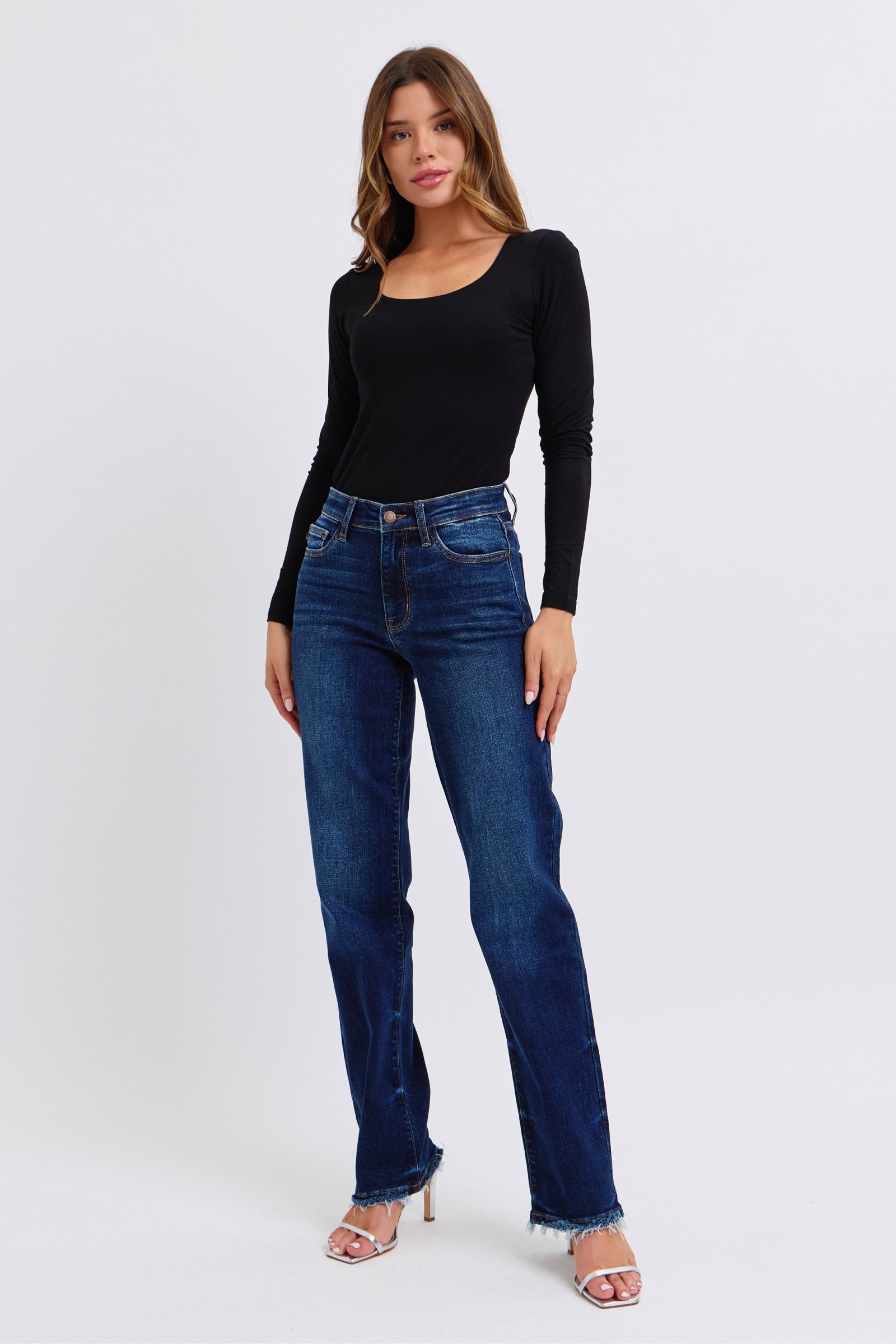 Judy Blue Raw Hem Straight Leg Jeans are a versatile and timeless addition to your wardrobe. The raw hem adds a touch of edge, while the straight leg style offers a flattering silhouette. Perfect for both casual and dressy looks, these jeans are a must-have for any fashion-forward individual. Front view