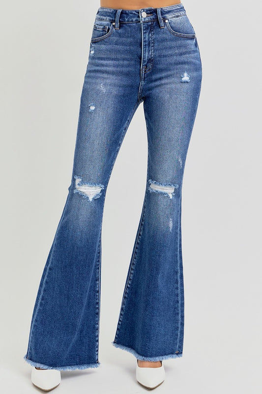 The Risen high rise distressed raw hem flare jeans are a trendy and stylish addition to your wardrobe. Featuring a flattering high-rise fit, these jeans offer a comfortable and supportive silhouette. The distressed detailing adds a touch of edge, while the raw hem gives them a modern, unfinished look. The flare leg creates a retro vibe, making them perfect for pairing with ankle boots or heels. Ideal for casual outings or dressed-up occasions, these jeans combine style with versatility! Front view
