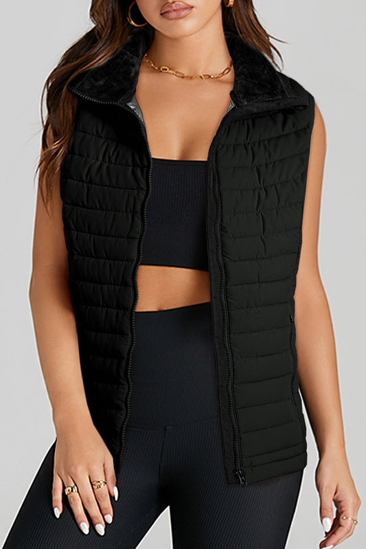 Stay on trend (and warm!) with this Black Quilted Zipped Puffer Vest. Versatile for any occasion, this vest is perfect for layering over any outfit. Plus, its unique quilted design and zip closure add a touch of style. Don't miss out on this must-have piece! front view