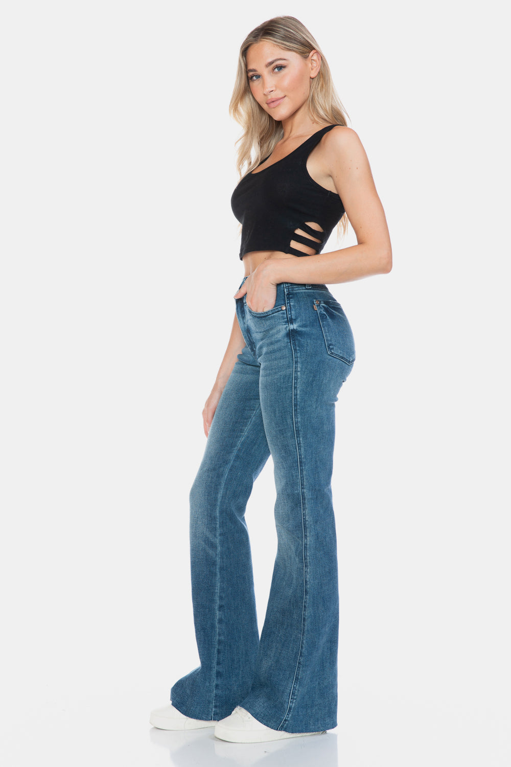 Judy Blue Mid-Rise Tummy Control Vintage Wash Cut Hem Flare is a stylish and flattering pair of jeans. With its tummy control feature, it helps create a streamlined silhouette. The vintage wash gives it a classic and timeless look. The cut hem flare adds a modern twist to the design. Perfect for any occasion, these jeans are versatile and comfortable to wear. Elevate your wardrobe with the Mid-Rise Tummy Control Vintage Wash Cut Hem Flare! Left side view