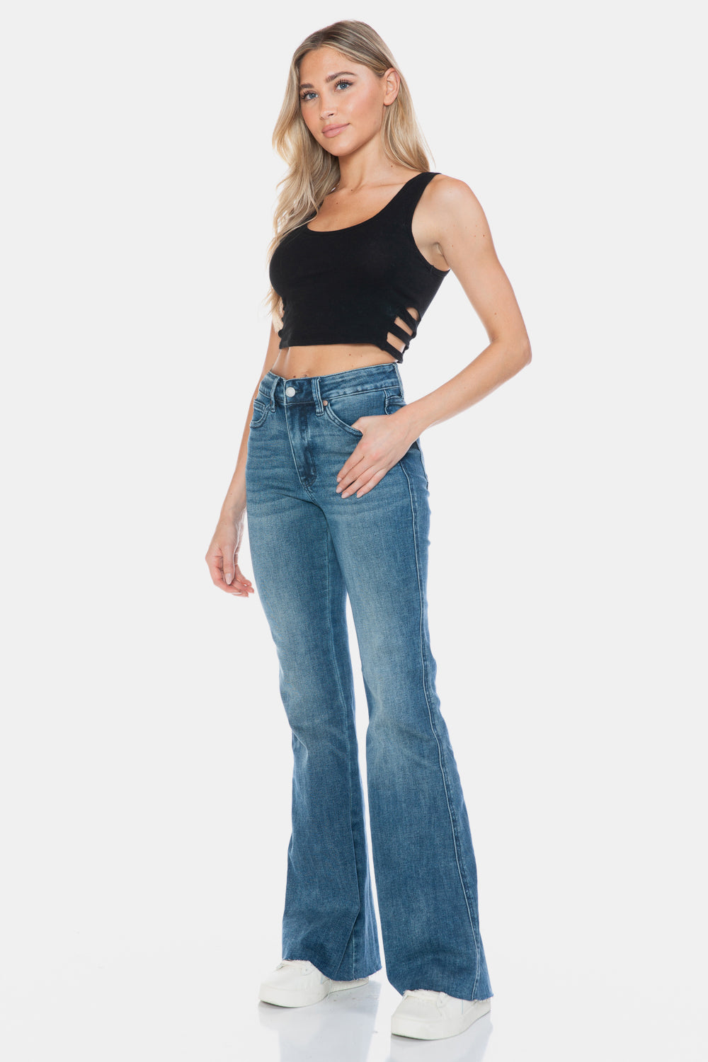 Judy Blue Mid-Rise Tummy Control Vintage Wash Cut Hem Flare is a stylish and flattering pair of jeans. With its tummy control feature, it helps create a streamlined silhouette. The vintage wash gives it a classic and timeless look. The cut hem flare adds a modern twist to the design. Perfect for any occasion, these jeans are versatile and comfortable to wear. Elevate your wardrobe with the Mid-Rise Tummy Control Vintage Wash Cut Hem Flare! Front left angle view