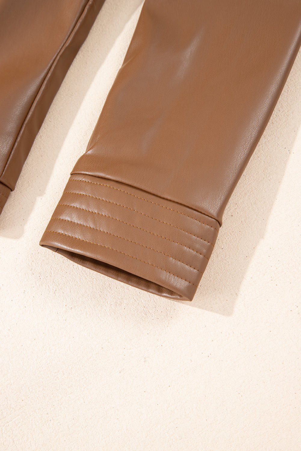 Chestnut faux leather slim fit bomber jacket. close up of cuff