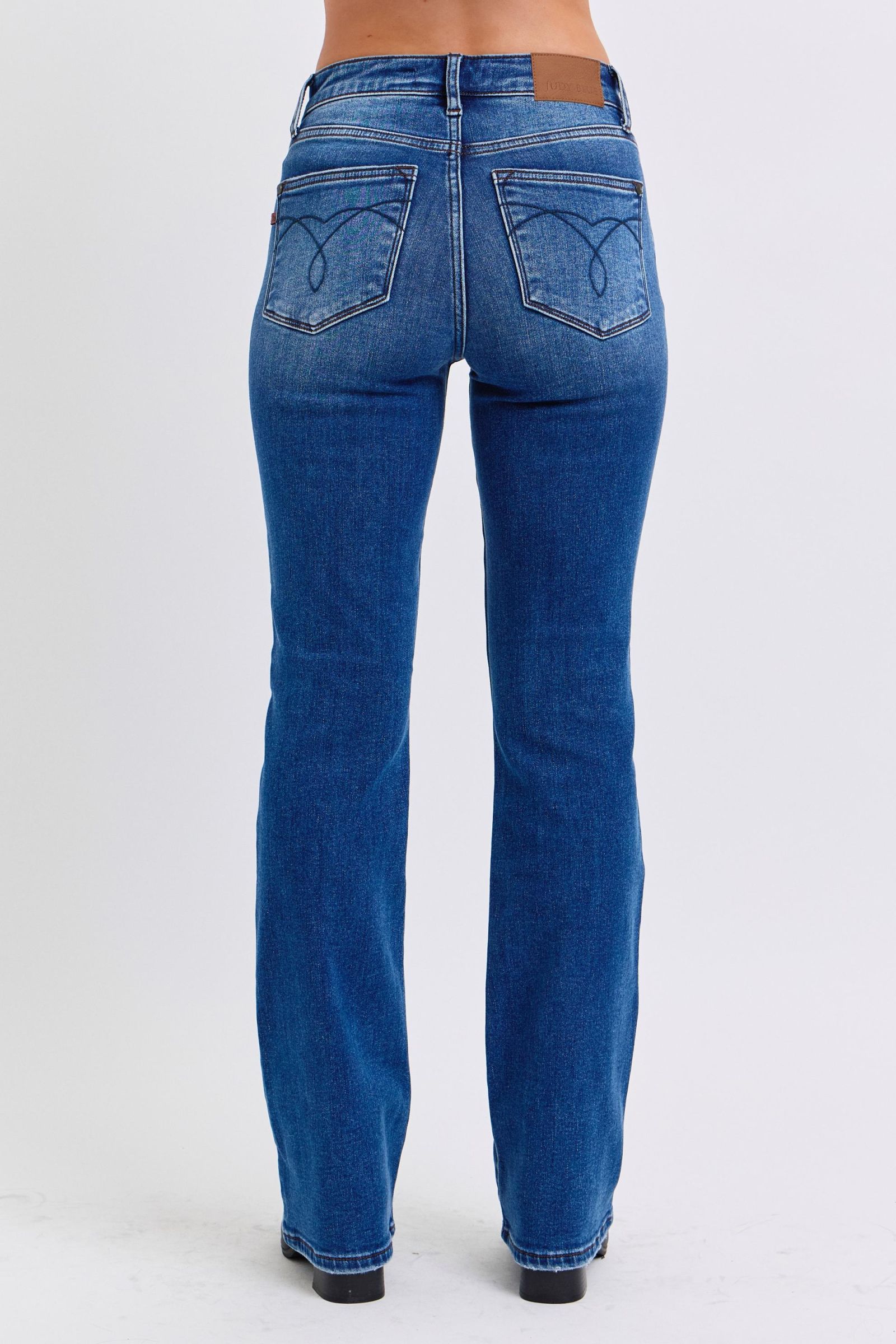 Judy Blue Mid-Rise Bootcut Jeans with thermal Lining. Featuring a mid-rise waist that offers a comfortable and flattering fit, these jeans accentuate the natural waistline. 
The bootcut silhouette flares slightly at the leg opening, creating a classic and elongating look. 
Designed with a thin thermal lining, these jeans provide lightweight warmth, making them perfect for cooler days. Back view