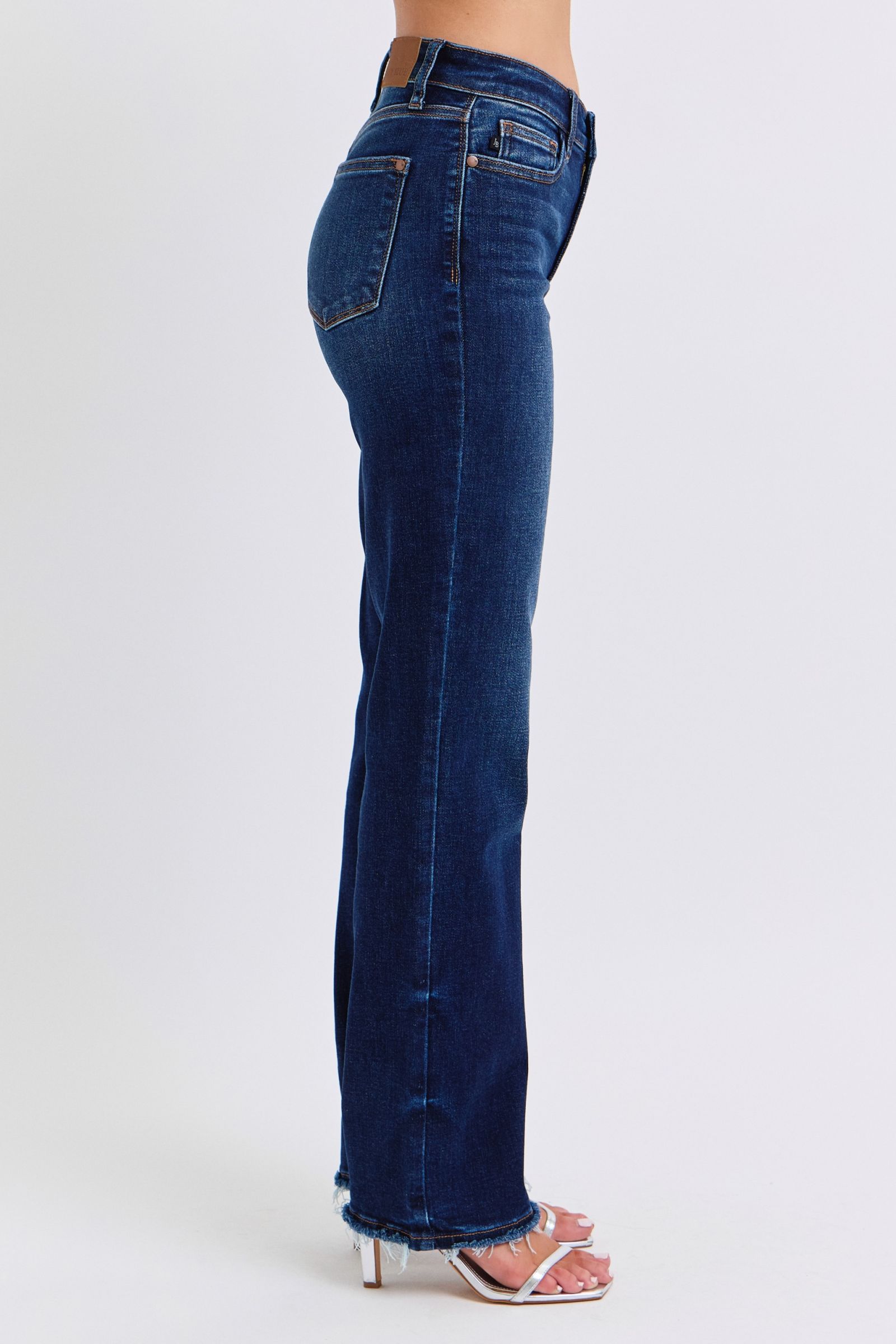 Judy Blue Raw Hem Straight Leg Jeans are a versatile and timeless addition to your wardrobe. The raw hem adds a touch of edge, while the straight leg style offers a flattering silhouette. Perfect for both casual and dressy looks, these jeans are a must-have for any fashion-forward individual. Right side view