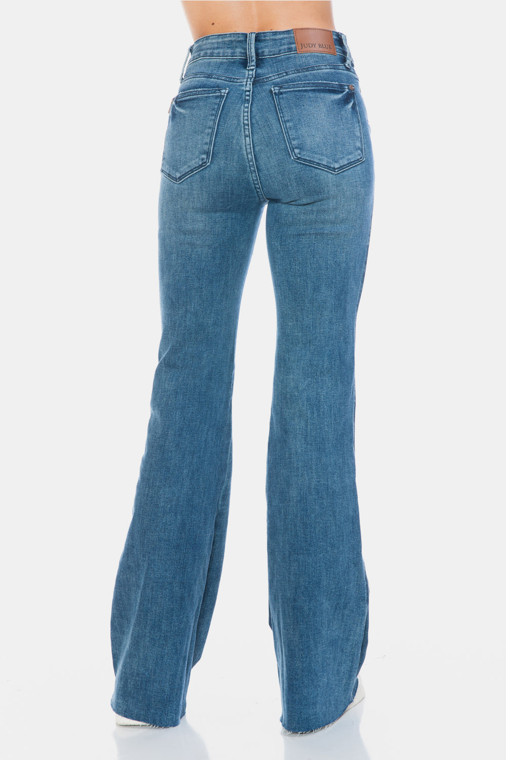 Judy Blue Mid-Rise Tummy Control Vintage Wash Cut Hem Flare is a stylish and flattering pair of jeans. With its tummy control feature, it helps create a streamlined silhouette. The vintage wash gives it a classic and timeless look. The cut hem flare adds a modern twist to the design. Perfect for any occasion, these jeans are versatile and comfortable to wear. Elevate your wardrobe with the Mid-Rise Tummy Control Vintage Wash Cut Hem Flare! Back view
