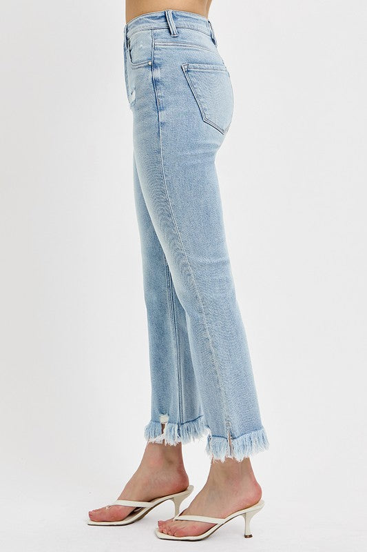 Risen Raw hem distressed cropped flare jeans offer a stylish and edgy twist to your denim collection. The cropped length hits above the ankle, making them perfect for showcasing your footwear. The flare silhouette adds a retro and fun vibe to the jeans, while the distressed detailing gives them a cool and worn-in look. The raw hem finish adds a touch of casual and laid-back charm to the jeans, making them ideal for a relaxed yet trendy outfit. Left side view