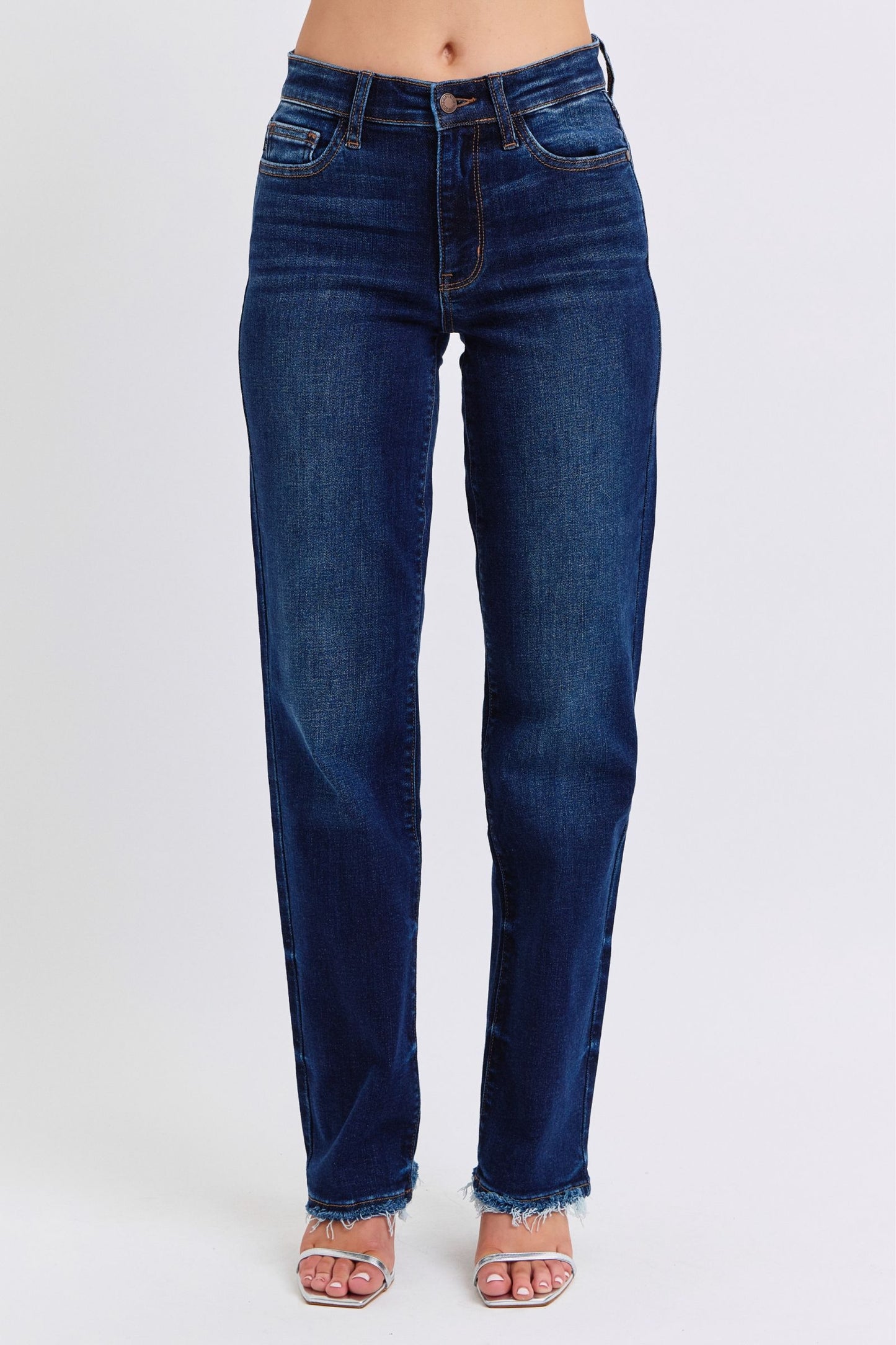 Judy Blue Raw Hem Straight Leg Jeans are a versatile and timeless addition to your wardrobe. The raw hem adds a touch of edge, while the straight leg style offers a flattering silhouette. Perfect for both casual and dressy looks, these jeans are a must-have for any fashion-forward individual. Front view