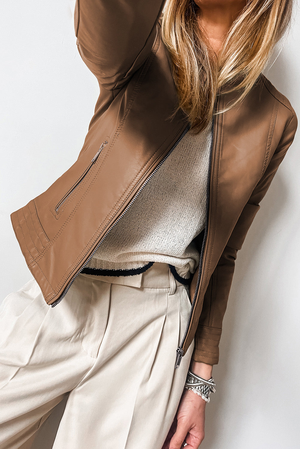 Blond woman wearing Chestnut faux leather slim fit bomber jacket. Front open view
