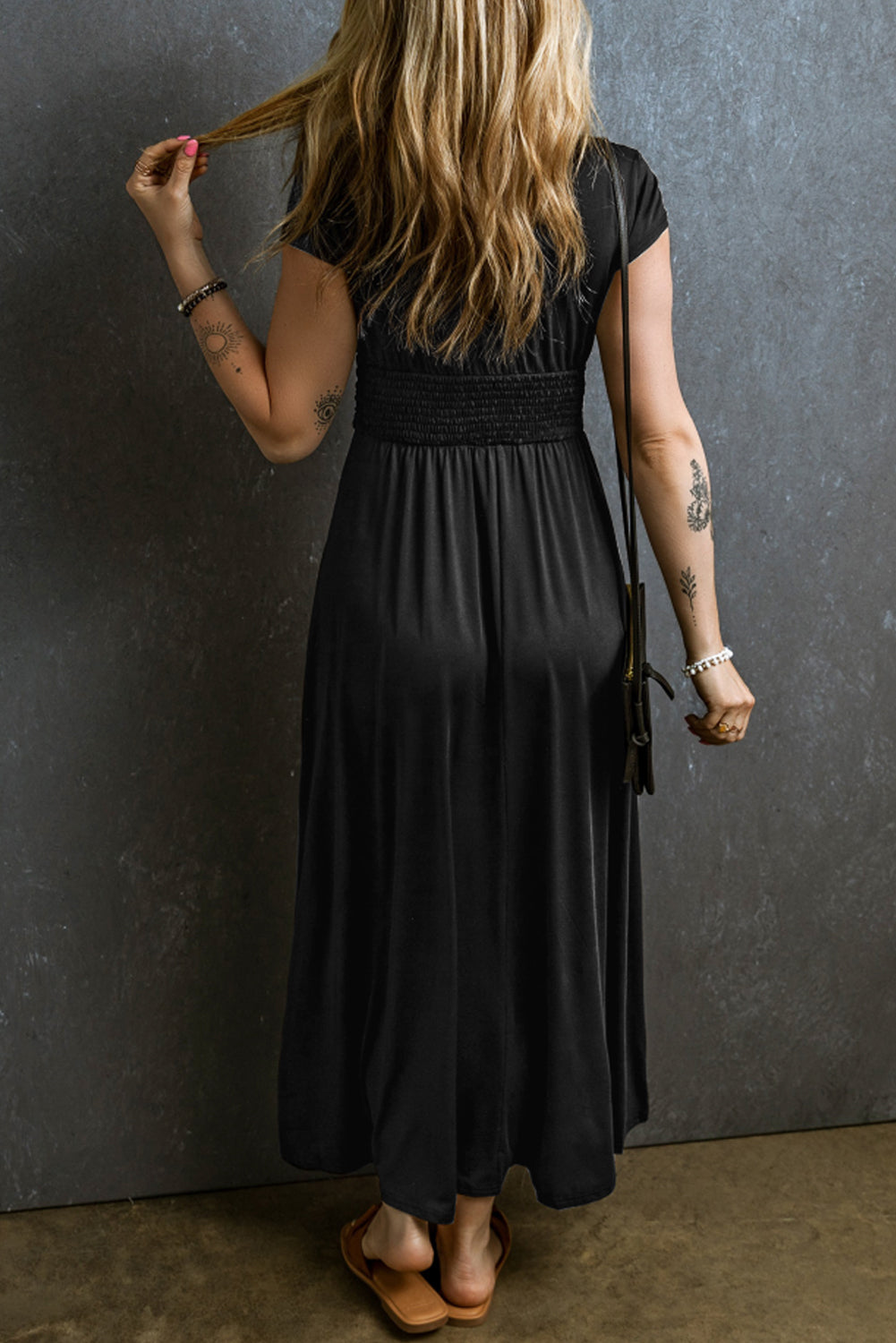 Woman wearing a black Maxi Dress with Short Sleeves, Shirred High Waist, V Neck. Back view